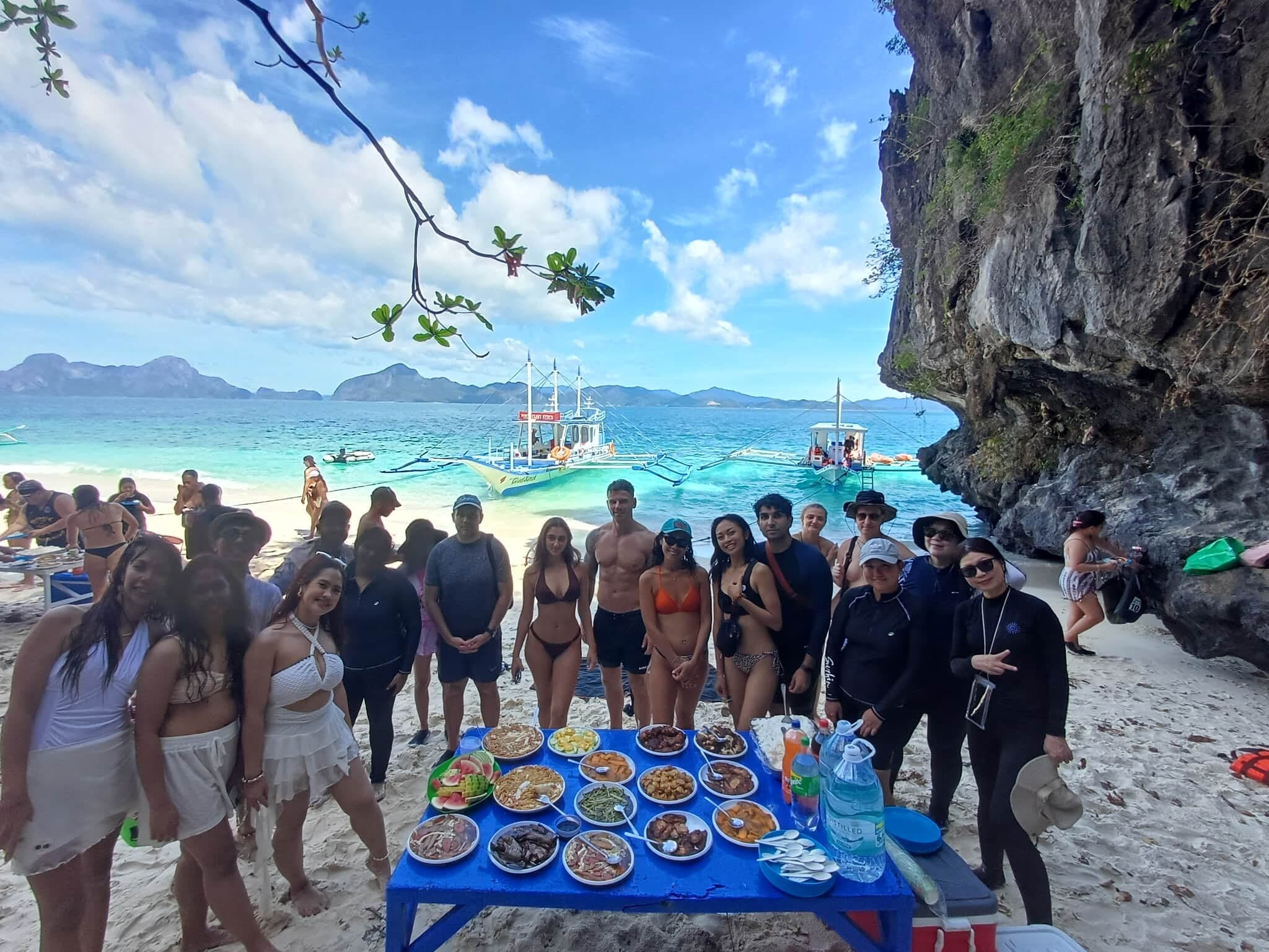 Group lunch setup on a beach during an island hopping tour