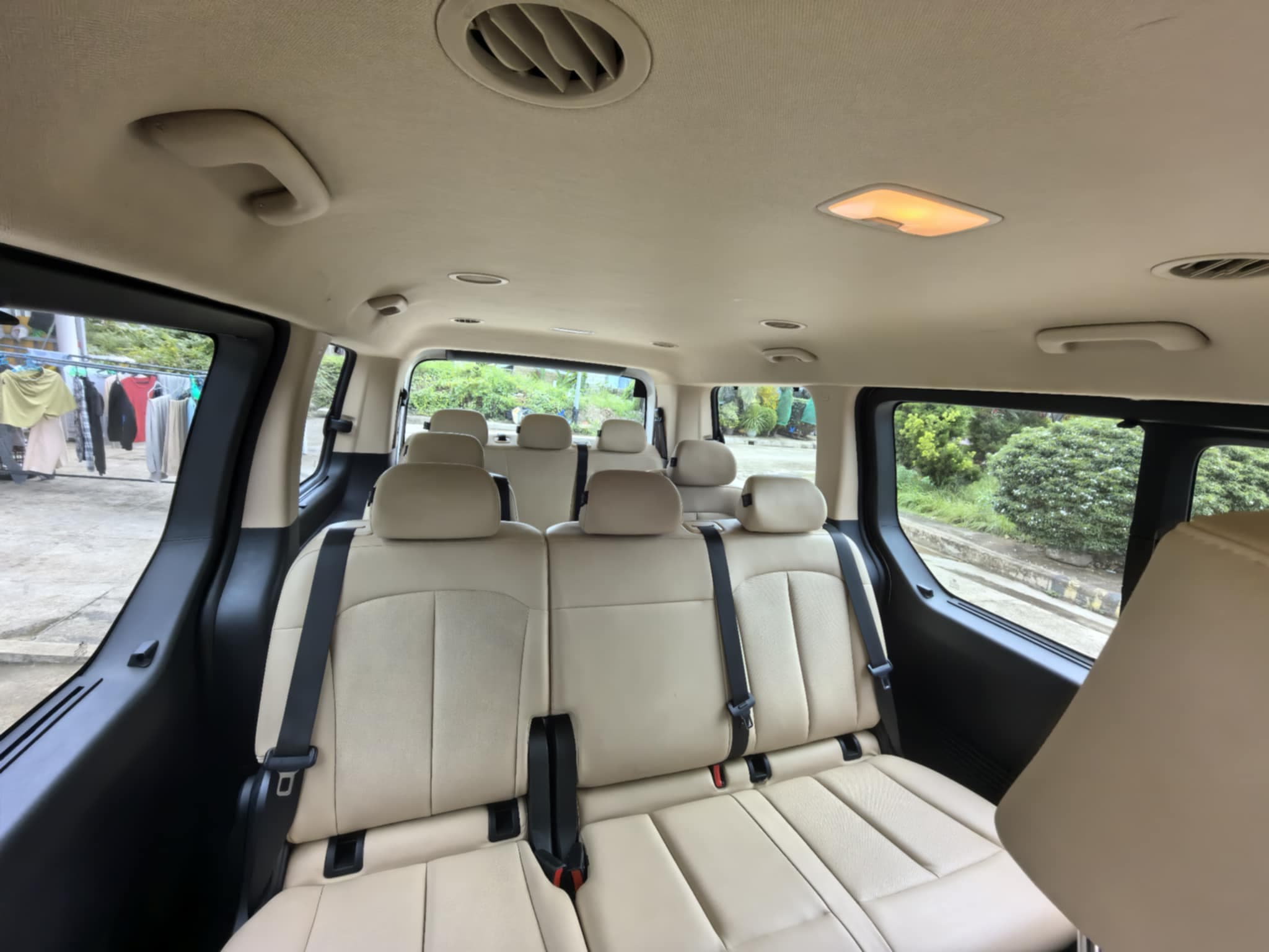 Van hire Puerto Princesa interior - premium beige leather seating Honda Bay city tour 11 passengers
